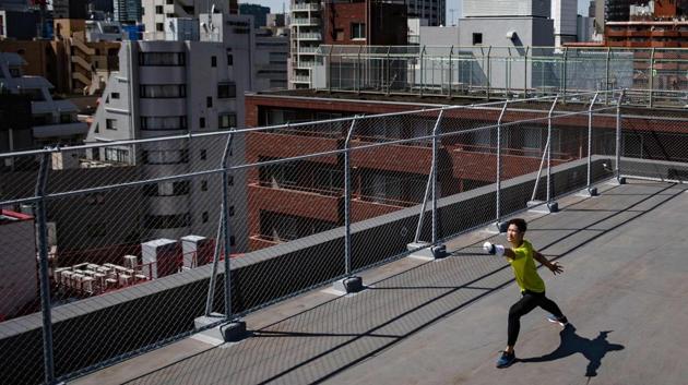 Miyake works out with a foil on the rooftop of a building in Tokyo. Japanese media have depicted Miyake as a poor amateur struggling to make ends meet but he himself asked for his three corporate sponsorships to be put on hold -- even if that means living off savings, reported AFP. (Philip Fong / AFP)