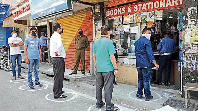 Part of the stress of shopping amid the lockdown comes from the sanitising, the wearing of masks, and the strange sight of socially distanced queues.(NITIN KANOTRA / HT PHOTO)