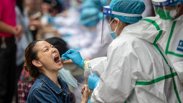 A medical worker takes a swab sample from a resident to be tested for the Covid-19 coronavirus, in a street in Wuhan in China's central Hubei province on May 15, 2020. (AFP photo) A medical worker takes a swab sample from a resident to be tested for the Covid-19 coronavirus, in a street in Wuhan in China's central Hubei province on May 15, 2020. (AFP photo)