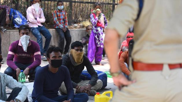 A group of migrants walking towards Uttar Pradesh are stopped by a police personnel, during lockdown, at the Indraprastha Estate Road, near Sarai Kale Khan in New Delhi. (Raj K Raj/HT PHOTO) A group of migrants walking towards Uttar Pradesh are stopped by a police personnel, during lockdown, at the Indraprastha Estate Road, near Sarai Kale Khan in New Delhi. (Raj K Raj/HT PHOTO)