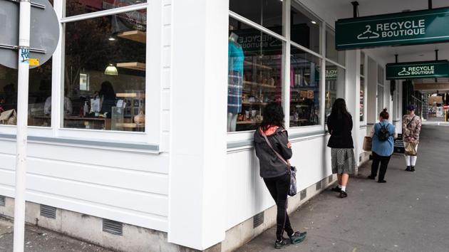 Customers maintain social distancing measures as they wait to enter a boutique in Wellington. Prime Minister Jacinda Ardern said in a statement that the Southern Hemisphere nation faces the most challenging economic conditions since the Great Depression because of the virus. (Birgit Krippner / Bloomberg) Customers maintain social distancing measures as they wait to enter a boutique in Wellington. Prime Minister Jacinda Ardern said in a statement that the Southern Hemisphere nation faces the most challenging economic conditions since the Great Depression because of the virus. (Birgit Krippner / Bloomberg)