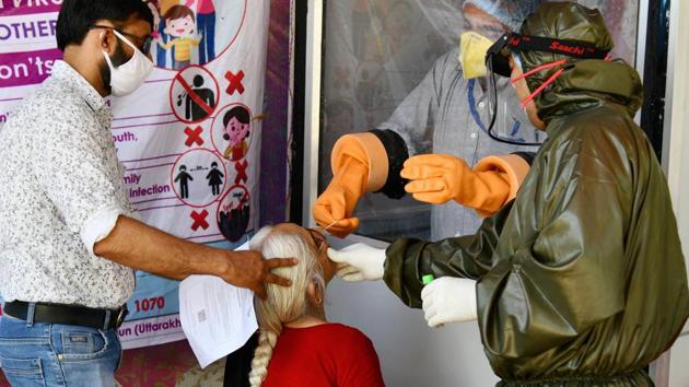 Dehradun: Medics take a swab sample of an elderly-woman for Covid-19 testing during the ongoing nationwide lockdown, in Dehradun on Friday (PTI Photo) Dehradun: Medics take a swab sample of an elderly-woman for Covid-19 testing during the ongoing nationwide lockdown, in Dehradun on Friday (PTI Photo)