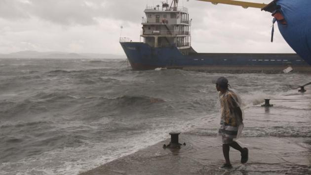 A man watches as strong waves caused by Typhoon Vongfong hit the coastline of Catbalogan city. (Simvale Sayat / AP)