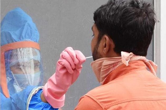 A health worker collects swabs from a man for a coronavirus test, Ranchi, Jharkhand(Diwakar Prasad/ HTPHOTO)