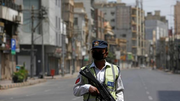 A police officer wearing a protective mask stands guard in Karachi, Pakistan. Image used for representational purpose only. (REUTERS)