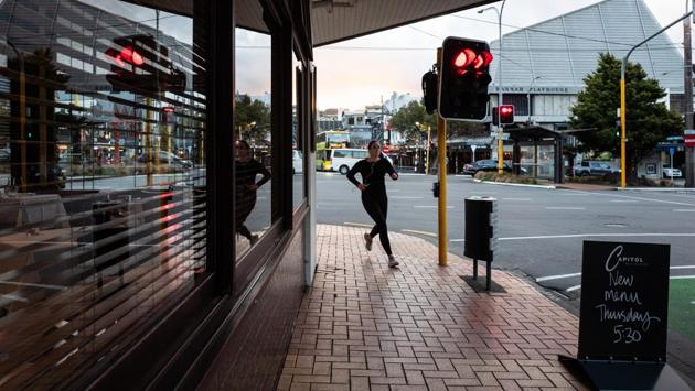 A woman runs past a restaurant in Wellington. More than 1,400 of the nearly 1,500 people who contracted COVID-19 have recovered, while 21 have died. (Birgit Krippner / Bloomberg) A woman runs past a restaurant in Wellington. More than 1,400 of the nearly 1,500 people who contracted COVID-19 have recovered, while 21 have died. (Birgit Krippner / Bloomberg)