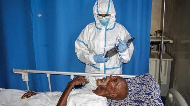 In this photo taken Wednesday, May, 13, 2020, a doctor tends to a patient in a ward for coronavirus patients at the Martini Hospital in Mogadishu, Somalia. Years of conflict, instability and poverty have left Somalia ill-equipped to handle a health crisis like the coronavirus pandemic.(AP)