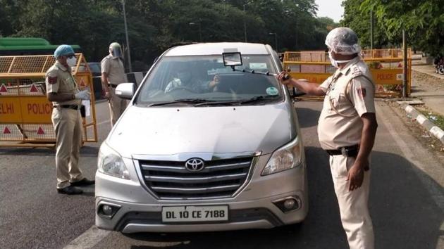 Cops checking a curfew pass via a selfie stick (sourced) Cops checking a curfew pass via a selfie stick (sourced)