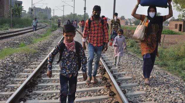 While two trains carrying migrants left Mohali railway station for Uttar Pradesh on Saturday, many migrants from Zirakpur decided to who could not get hold of the tickets decided to walk along the railroads, hoping to reach home soon. (HT PHOTO) While two trains carrying migrants left Mohali railway station for Uttar Pradesh on Saturday, many migrants from Zirakpur decided to who could not get hold of the tickets decided to walk along the railroads, hoping to reach home soon. (HT PHOTO)
