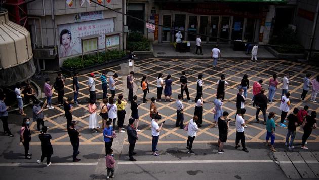 Residents line up for nucleic acid testings at a residential compound in Wuhan. Some eight million residents of Wuhan, the Chinese city where the coronavirus first emerged late last year, are undergoing the world’s largest mass testing for Covid-19. (Aly Song / REUTERS)