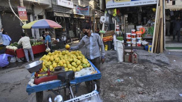 Shops open in a market during lockdown in Bharat Nagar, New Delhi.(Burhaan Kinu/HT PHOTO)