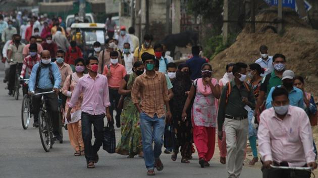 Industrial workers walking towards their factories in Udyog Vihar wearing masks, in Gurugram. (Yogendra Kumar/HT PHOTO) Industrial workers walking towards their factories in Udyog Vihar wearing masks, in Gurugram. (Yogendra Kumar/HT PHOTO)