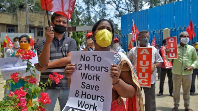 Activists of Joint Committee of Trade Unions (JCTU) take part in an anti-government protest against the increase in working hours of employees in various industrial sectors from 8 hours to 12 hours a day, near labour department in Bangalore.(AFP)