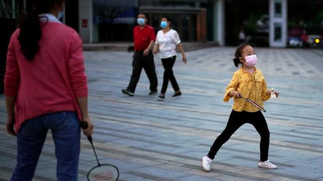 A little girl wearing a face mask seen playing badminton. The current tests are being carried out five weeks after Wuhan opened up on April 8 after a 76-day lockdown. (Aly Song / REUTERS)