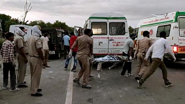 Police personnel take an injured to hospital as 24 migrant laborers died and others got injured after the truck in which they traveling collided with another truck in Auraiya on May 16.(ANI)