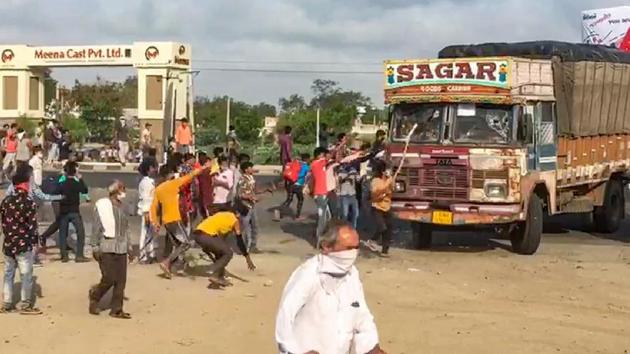 Migrants damage a truck demanding means of transport to travel to their native places (PTI Photo) Migrants damage a truck demanding means of transport to travel to their native places (PTI Photo)