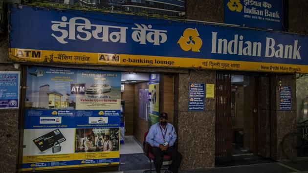 A security guard wearing a protective mask sits at the entrance of an Indian Bank branch at Connaught Place. The finance minister detailed the break-up of the ₹20 lakh crore package which includes liquidity measures of ₹8 lakh crore announced by the RBI earlier as well as the PM Gareeb Kalyan Yojna. (Prashanth Vishwanathan / Bloomberg)