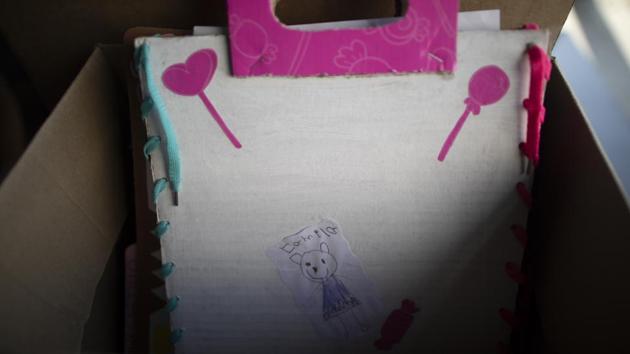 A folder made by hand ,containing the schoolwork of a pupil Camila, who identified it with a drawing of herself instead of a photo. For students who can’t get online at all, the school set up cardboard boxes in the cafeteria where parents drop off their child’s homework. Teachers correct it and put it in notebooks to be picked up along with another two weeks of homework. (Ariana Cubillos / AP) A folder made by hand ,containing the schoolwork of a pupil Camila, who identified it with a drawing of herself instead of a photo. For students who can’t get online at all, the school set up cardboard boxes in the cafeteria where parents drop off their child’s homework. Teachers correct it and put it in notebooks to be picked up along with another two weeks of homework. (Ariana Cubillos / AP)