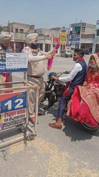Sub-inspector Harinder Singh and assistant sub-inspector Gurmeet Singh stopped the couple who were returning from the ceremony on a two-wheeler.(HT PHOTO)