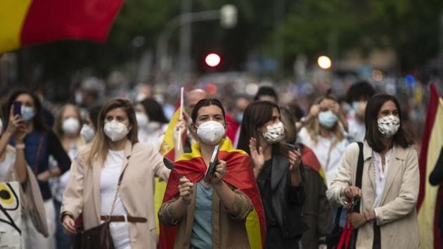 People take part in a protest against the Spanish government amid the lockdown in Madrid on May 17. Many marchers carried Spanish flags and shouted out “Freedom!” Spain’s far-right Vox party and the conservative leader of the region have voiced their support for the protests saying that the city’s economy must restart soon to save jobs. (AP / PTI)