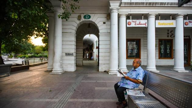 An elderly man reads newspaper on a deserted Connaught Place amid the lockdown in New Delhi on Monday.(Amal KS/HT PHOTO)