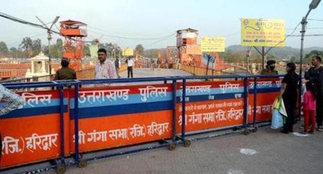 Uttarakhand: Security personnel cordoned off the entrance of Har Ki Pauri ghat to not enter the devotees after the government banned public gatherings as a preventive measure against coronavirus, in Haridwar on March 19. (ANI) Uttarakhand: Security personnel cordoned off the entrance of Har Ki Pauri ghat to not enter the devotees after the government banned public gatherings as a preventive measure against coronavirus, in Haridwar on March 19. (ANI)