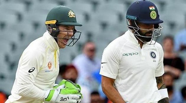 Australia's captain Tim Paine (L) celebrates as India's captain Virat Kohli leaves the field(REUTERS)