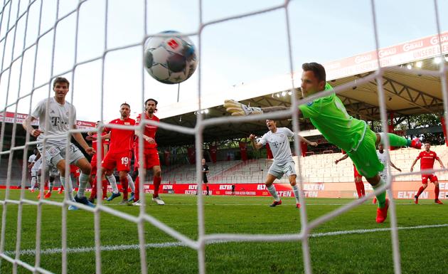 Bayern Munich's Benjamin Pavard (hidden) scores their second goal, as play resumes behind closed doors in Bundesliga. (REUTERS)