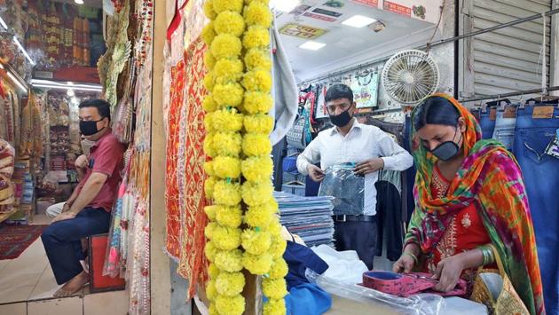 A shopkeeper looks on while a customer browses products at a shop. Exemptions to marketplace guidelines allow for essential goods shops to remain open regardless of the odd-even rule. Shopping malls, cinema halls as well as liquor stores in malls will however, continue to remain off-limits. (Prabhat Mehrotra / ANI)