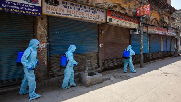 A team of NDMC workers chemically disinfect closed shops in Kashmere Gate, New Delhi  on May 18. Until May 20, 10,554 people were infected in Delhi and out of these 4,750 have recovered from the infection.  (Amal KS / HT Photo) 