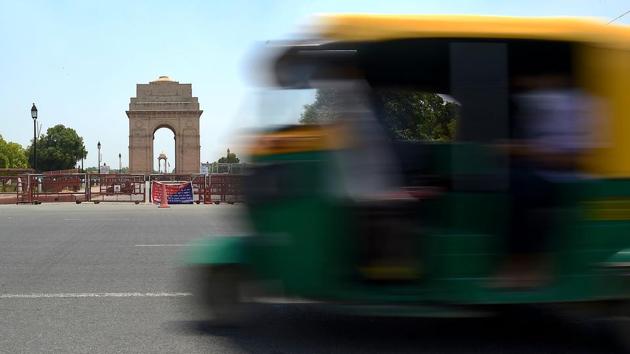 An auto-rickshaw drives past India Gate after the government eased restrictions imposed as a preventive measure against the coronavirus in New Delhi on May 19. After a nearly two month hiatus, the national capital took a restrained step towards normalcy with the revival of transport services and marketplaces. (Money Sharma / AFP)