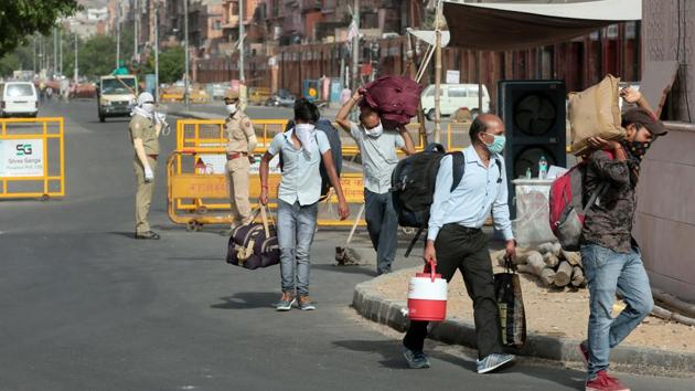 People carrying luggage pass barricades placed at the Ramganj coronavirus hotspot in Jaipur, Rajasthan on Monday. (Himanshu Vyas/HT Photo) People carrying luggage pass barricades placed at the Ramganj coronavirus hotspot in Jaipur, Rajasthan on Monday. (Himanshu Vyas/HT Photo)
