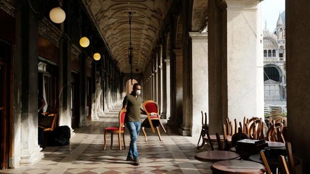 Gran Caffe Chioggia in St. Mark Square prepares for its reopening in Venice on May 18. Italy was the first European country to impose nationwide restrictions, only permitting an initial relaxation of the rules on May 4, when it allowed factories and parks to reopen. (Manuel Silvestri / REUTERS)