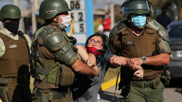 A woman is detained during the protest. Many of the demands lodged by protesters last year, from increased pensions to higher pay remain unresolved. (Ivan Alvarado / REUTERS)