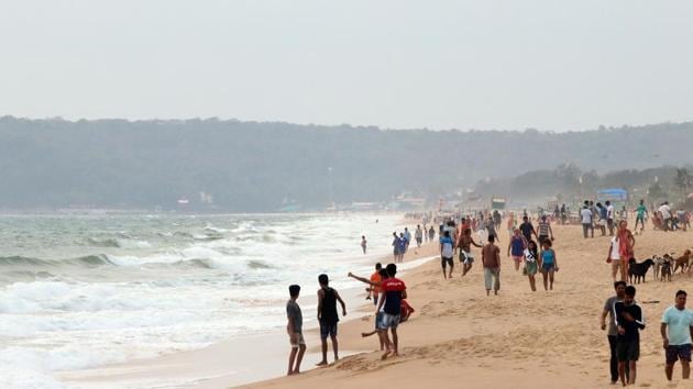 People and stranded migrants relaxing at the Candolim- Calangute Beach on Saturday. (ANI photo) People and stranded migrants relaxing at the Candolim- Calangute Beach on Saturday. (ANI photo)