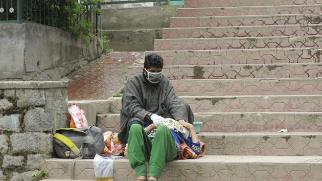 A person suspected of Covid-19 seen with an attendant on the stairs of Chest Disease Hospital, in Srinagar on Monday. (Waseem Andrabi/HT Photo) A person suspected of Covid-19 seen with an attendant on the stairs of Chest Disease Hospital, in Srinagar on Monday. (Waseem Andrabi/HT Photo)