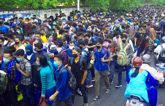 Stranded people gather at Palace Grounds to board buses to reach Malur and Chikkabanavara Railway Station to go to their native place during the Covid-19 lockdown in Bengaluru on Tuesday. (ANI Photo) (ANI Photo) Stranded people gather at Palace Grounds to board buses to reach Malur and Chikkabanavara Railway Station to go to their native place during the Covid-19 lockdown in Bengaluru on Tuesday. (ANI Photo) (ANI Photo)