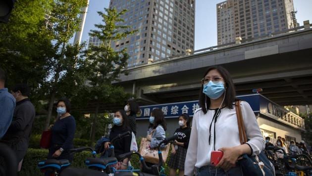 Commuters wearing face masks to protect against the new coronavirus walk through the central business district in Beijing, Tuesday, May 19, 2020. China reported six new cases Tuesday, a day after Chinese President Xi Jinping announced his country would provide $2 billion to help respond to the outbreak and its economic fallout. (AP Photo/Mark Schiefelbein) (AP) Commuters wearing face masks to protect against the new coronavirus walk through the central business district in Beijing, Tuesday, May 19, 2020. China reported six new cases Tuesday, a day after Chinese President Xi Jinping announced his country would provide $2 billion to help respond to the outbreak and its economic fallout. (AP Photo/Mark Schiefelbein) (AP)