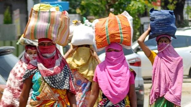 Women carrying essential items walk along a road on a hot summer day during the ongoing Covid-19 lockdown in Nagpur. (PTI File Photo) Women carrying essential items walk along a road on a hot summer day during the ongoing Covid-19 lockdown in Nagpur. (PTI File Photo)