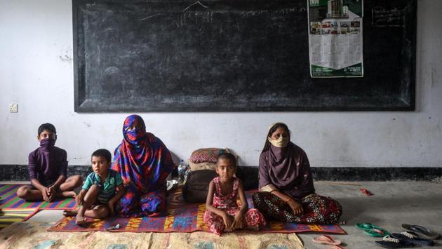 Residents in a shelter ahead of the expected landfall of cyclone Amphan in Dacope of Khulna district, Bangladesh on May 20. India and Bangladesh have asked for schools and other buildings to be turned into temporary shelters, but more space is needed than usual in order to house people while maintaining social distancing. (Munir Uz Zaman / AFP)
