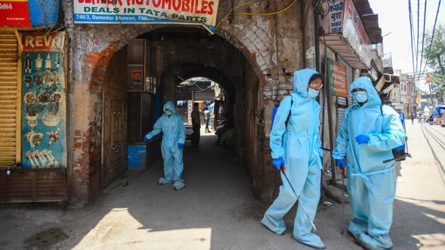 A team of New Delhi Municipal Council (NDMC) workers disinfect a marketplace in Kashmere Gate on May 18. Delhi Government opened up the city’s markets on May 19 after nearly two months of a sweeping lockdown.  (Amal KS / HT Photo) 