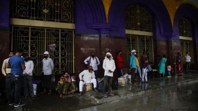 Stranded passengers wait outside Howrah railway station, which is closed due to the extremely severe cyclonic storm Amphan, in Kolkata on May 20. Amphan, a powerful cyclone has slammed ashore along the coastline of India and Bangladesh, where more than 2.6 million people fled to shelters in a frantic evacuation made all the more challenging by the coronavirus pandemic. (Bikas Das / AP)