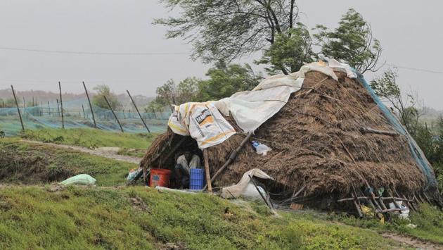 A man takes shelter from the wind and rain inside a hut ahead at Bhadrak district, Odisha, on May 20. “Based on experiences during Cyclone Fani, all NDRF teams are equipped with tree cutters/pole cutters for post landfall restoration, if need arises. We have deployed at least 24 NDRF teams to begin restoration work,” NDRF Director General SN Pradhan said. (AP)