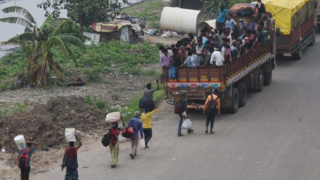 Heartbreaking scenes such as this, where migrant workers are seen headed to their homes, queuing up behind a truck already bursting at its seams, have become common on a daily basis across India’s national highways. This image was made on  National Highway NH 30 in Patna on May 18.  (Parwaz Khan / HT Photo) 