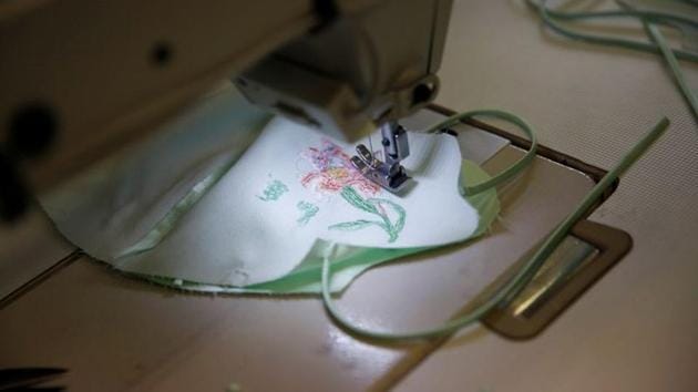 A piece of melt-blown fabric is seen sewed with silk cloth for making a face mask that is designed by Zhou Li, at a studio in Beijing, following the novel coronavirus disease (COVID-19) outbreak, China May 17, 2020. Picture taken May 17, 2020. REUTERS/Tingshu Wang (REUTERS) A piece of melt-blown fabric is seen sewed with silk cloth for making a face mask that is designed by Zhou Li, at a studio in Beijing, following the novel coronavirus disease (COVID-19) outbreak, China May 17, 2020. Picture taken May 17, 2020. REUTERS/Tingshu Wang (REUTERS)