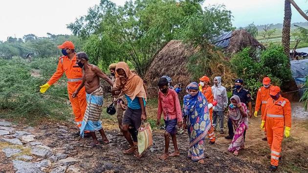 National Disaster Response Force (NDRF) personnel evacuate villagers from low lying seaside areas ahead of cyclone Amphan’s landfall near Dhamra in Bhadrak district on May 19. Odisha government had evacuated over 1.37 lakh people from the coastal and adjoining districts into makeshift shelter homes until the evening of May 19. (PTI) National Disaster Response Force (NDRF) personnel evacuate villagers from low lying seaside areas ahead of cyclone Amphan’s landfall near Dhamra in Bhadrak district on May 19. Odisha government had evacuated over 1.37 lakh people from the coastal and adjoining districts into makeshift shelter homes until the evening of May 19. (PTI)