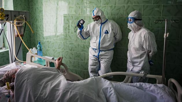 Doctor Dmitry Cheboksarov (L) wearing personal protective equipment (PPE) works in the intensive care unit for the COVID-19 coronavirus patients at Vinogradov City Clinical Hospital in Moscow. For the first time yesterday, Russia recorded more people recovering in the last 24 hours than the number of people testing positive. (Dimitar Dilkoff / AFP)