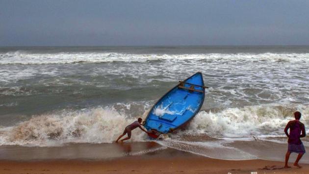 Fishermen control a boat amid rough sea waters ahead of the landfall of Cyclone Amphan at Puri beach on May 19. Amphan is poised to slam into West Bengal and Odisha on Wednesday afternoon, packing winds gusting to a speed of 185 kmph, bringing with it torrential rainfall, threatening to inundate low-lying areas and cause extensive damage to crops and public property. (PTI) Fishermen control a boat amid rough sea waters ahead of the landfall of Cyclone Amphan at Puri beach on May 19. Amphan is poised to slam into West Bengal and Odisha on Wednesday afternoon, packing winds gusting to a speed of 185 kmph, bringing with it torrential rainfall, threatening to inundate low-lying areas and cause extensive damage to crops and public property. (PTI)