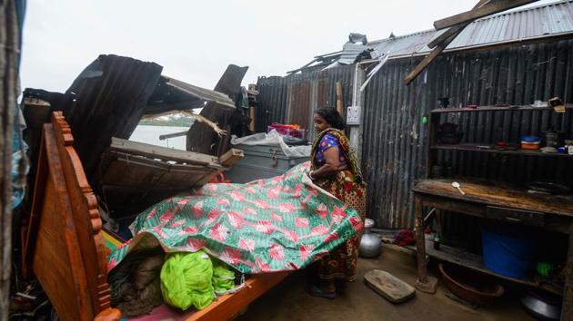 A woman salvages items from her house damaged by Cyclone Amphan in Satkhira, Bangladesh on May 21. The strongest cyclone in decades slammed into Bangladesh and eastern India on May 20, sending water surging inland and leaving a trail of destruction as the death toll rose to nine in Bangladesh. (Munir Uz Zaman / AFP)