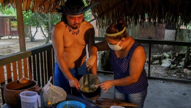 Satere-Mawe indigenous people prepare medicinal herbs to treat people with symptoms of COVID-19 in the Wakiru community. The virus has raised fear among the region’s indigenous peoples, who have a tragic history of being decimated by diseases brought in from the outside world. (Ricardo Oliveira / AFP)
